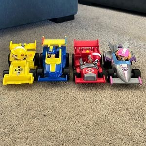 4 gently used Paw Patrol race cars and characters. Only used inside!!